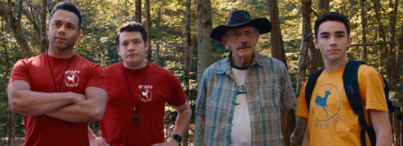 four actors standing in the woods camp hideout